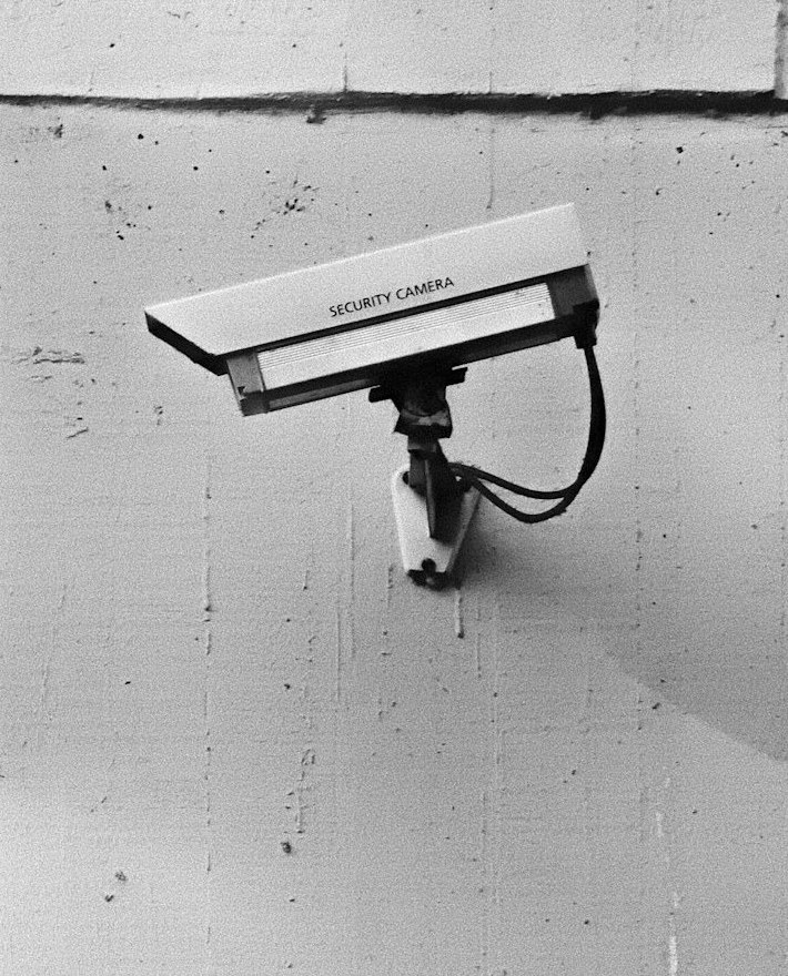 Security camera mounted on a white wall